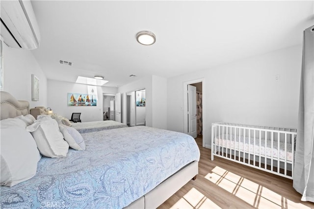 18536 Mescal St, Rowland Heights, CA 91748 - bedroom featuring a wall mounted AC and wood finished floors