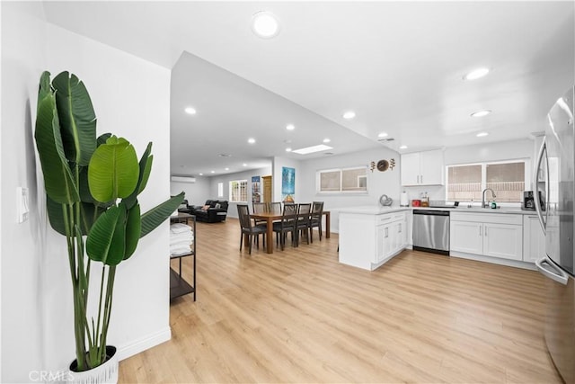 18536 Mescal St, Rowland Heights, CA 91748 - kitchen featuring appliances with stainless steel finishes, a peninsula, open floor plan, recessed lighting, and white cabinets
