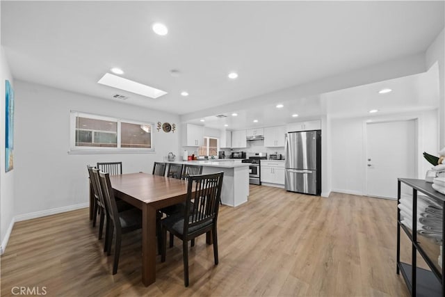 18536 Mescal St, Rowland Heights, CA 91748 - dining room featuring recessed lighting, light wood-type flooring, and a skylight