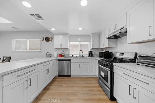 18536 Mescal St, Rowland Heights, CA 91748 - kitchen featuring appliances with stainless steel finishes, under cabinet range hood, white cabinets, light countertops, and recessed lighting