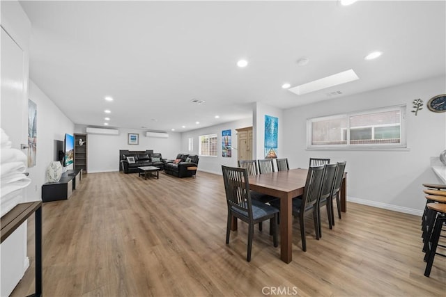 18536 Mescal St, Rowland Heights, CA 91748 - dining room with a skylight, light wood-style floors, recessed lighting, and a wall unit AC