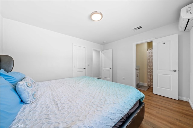 18536 Mescal St, Rowland Heights, CA 91748 - bedroom with an AC wall unit and wood finished floors
