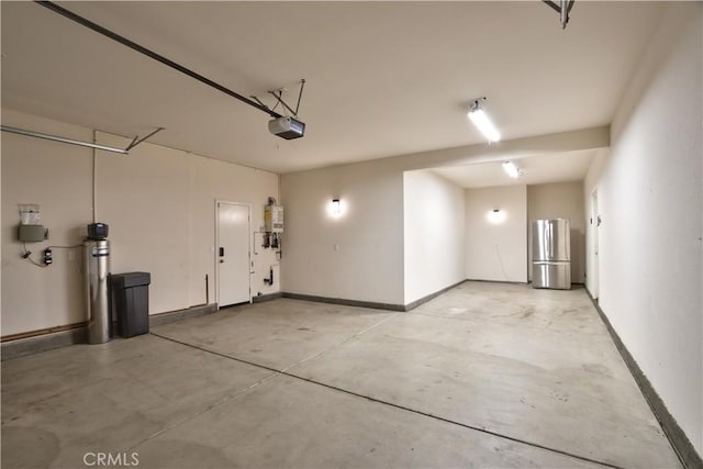 27974 Garda Ct, Menifee, CA 92585 - garage featuring freestanding refrigerator, a garage door opener, and water heater