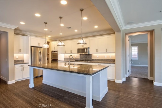 27974 Garda Ct, Menifee, CA 92585 - kitchen with appliances with stainless steel finishes, dark wood finished floors, a center island with sink, crown molding, and backsplash