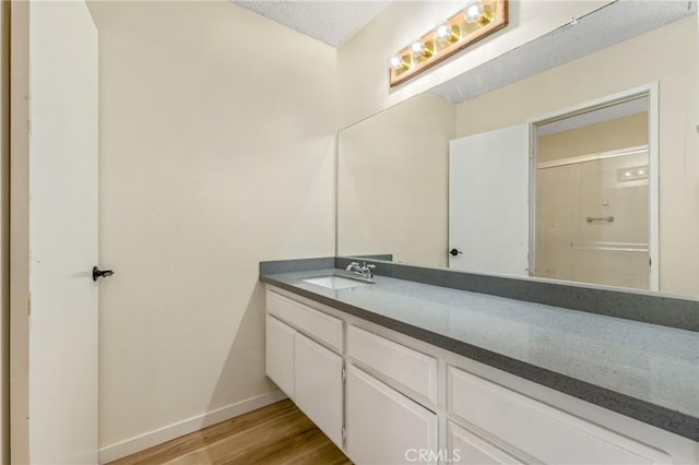 2321 S Magnolia Ave Unit 6E, Ontario, CA 91762 - full bath with vanity, wood finished floors, and an enclosed shower