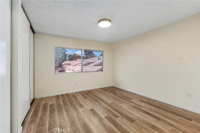 2321 S Magnolia Ave Unit 6E, Ontario, CA 91762 - spare room with light wood-style floors and a textured ceiling