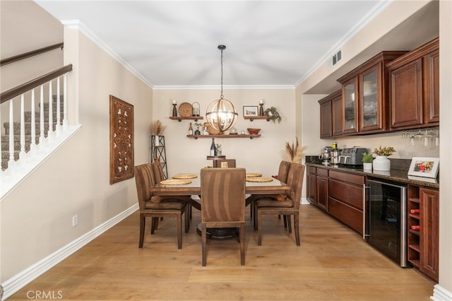 14131 Apple Grove Ct, Eastvale, CA 92880 - dining area with wine cooler, stairs, a chandelier, light wood-style floors, and ornamental molding