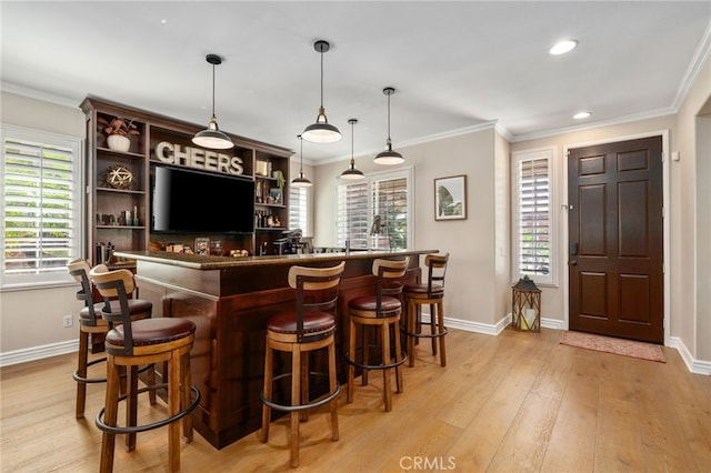 14131 Apple Grove Ct, Eastvale, CA 92880 - indoor wet bar featuring light wood-style floors, crown molding, recessed lighting, and pendant lighting
