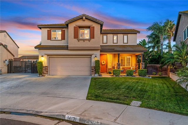14131 Apple Grove Ct, Eastvale, CA 92880 - view of front facade featuring covered porch, stucco siding, driveway, a garage, and stone siding