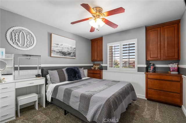 14131 Apple Grove Ct, Eastvale, CA 92880 - bedroom with dark carpet, a wainscoted wall, and ceiling fan