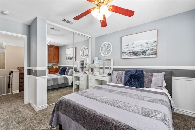 14131 Apple Grove Ct, Eastvale, CA 92880 - bedroom with carpet flooring, a closet, wainscoting, and a ceiling fan
