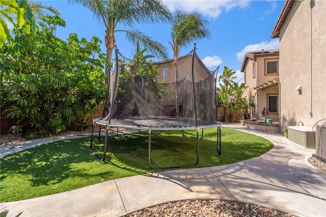 14131 Apple Grove Ct, Eastvale, CA 92880 - fenced backyard with a trampoline and a patio