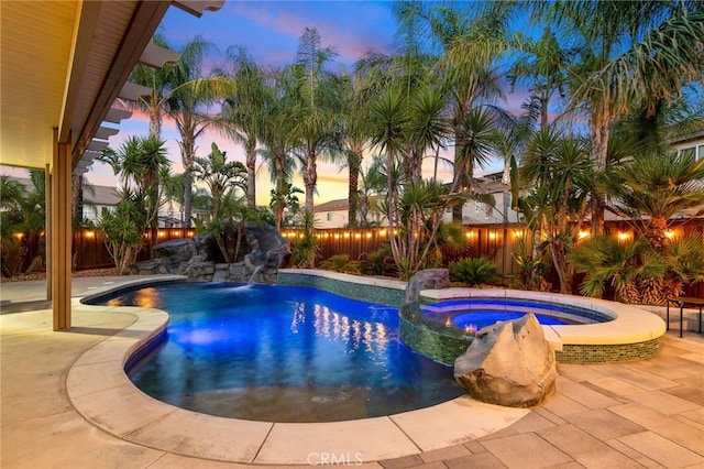 14131 Apple Grove Ct, Eastvale, CA 92880 - pool at dusk featuring a fenced backyard and a pool with connected hot tub