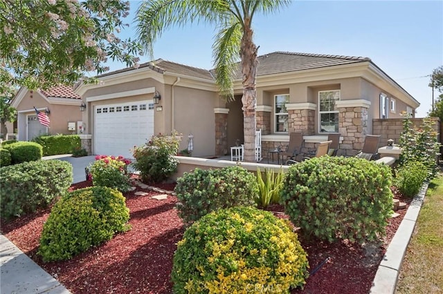 1627 Camino Sueno, Hemet, CA 92545 - view of front of house featuring stucco siding, stone siding, a garage, and a tile roof
