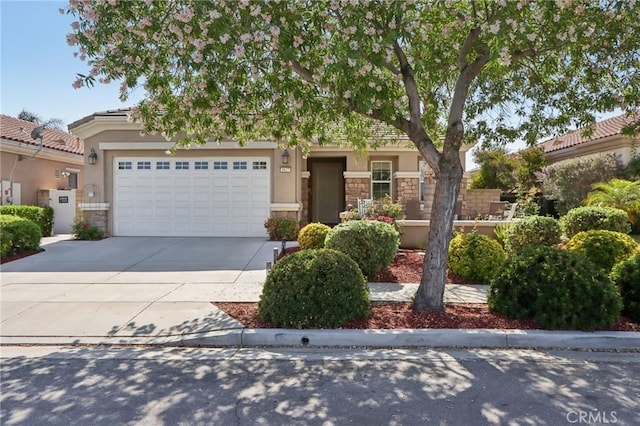 1627 Camino Sueno, Hemet, CA 92545 - view of front of property featuring stone siding, concrete driveway, stucco siding, and a garage