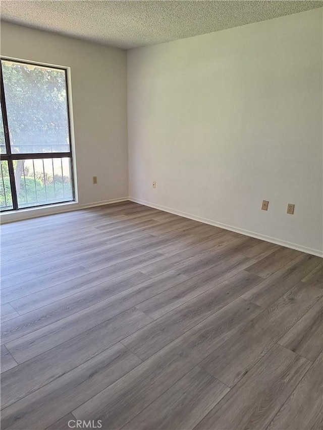 3144 Via Vis Unit Q, Laguna Woods, CA 92637 - spare room with dark wood finished floors and a textured ceiling