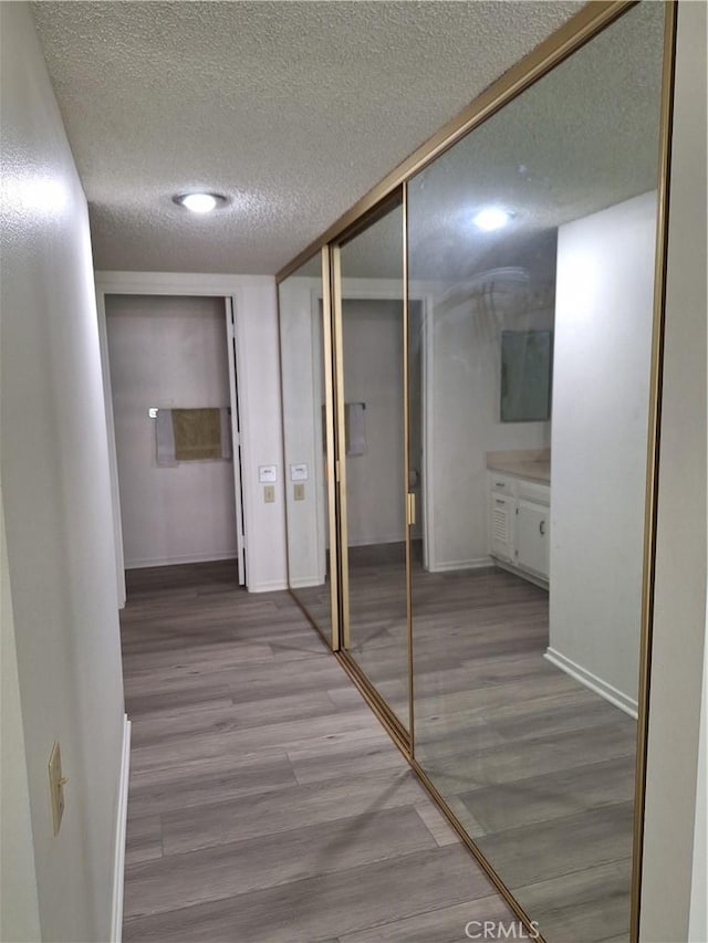 3144 Via Vis Unit Q, Laguna Woods, CA 92637 - corridor with a textured ceiling and light wood-type flooring