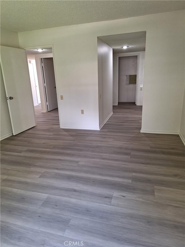 3144 Via Vis Unit Q, Laguna Woods, CA 92637 - unfurnished room with wood finished floors and a textured ceiling