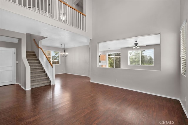 11890 Greenbluff Way, Yucaipa, CA 92399 - unfurnished living room with wood finished floors, a chandelier, plenty of natural light, a towering ceiling, and stairway