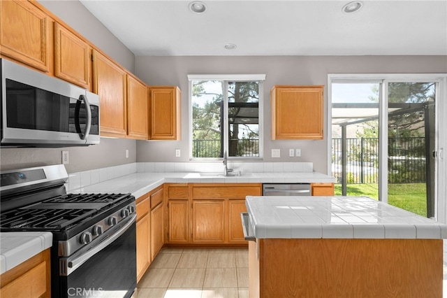 11890 Greenbluff Way, Yucaipa, CA 92399 - kitchen featuring appliances with stainless steel finishes, tile counters, light tile patterned flooring, and recessed lighting