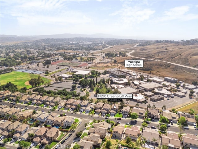 11890 Greenbluff Way, Yucaipa, CA 92399 - aerial view of property's location featuring a mountain backdrop and nearby suburban area