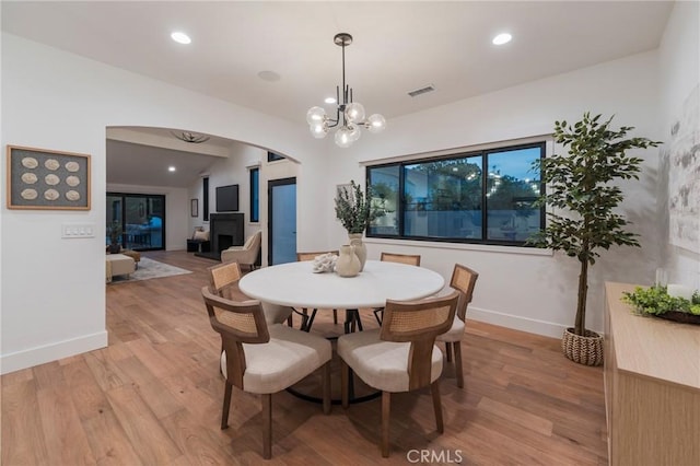 35 Beachcomber Dr, Corona Del Mar, CA 92625 - dining area featuring vaulted ceiling, arched walkways, light wood-style flooring, a chandelier, and recessed lighting