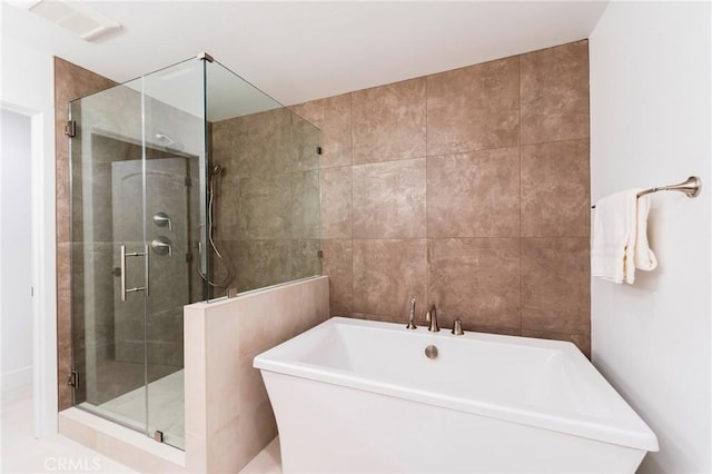 35 Beachcomber Dr, Corona Del Mar, CA 92625 - bathroom featuring a shower stall, a freestanding bath, and tile walls