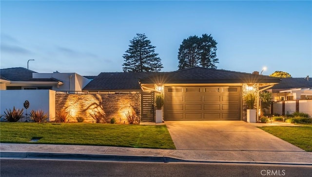 35 Beachcomber Dr, Corona Del Mar, CA 92625 - view of front of home with a garage, concrete driveway, a front lawn, and stone siding