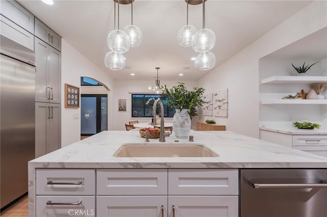 35 Beachcomber Dr, Corona Del Mar, CA 92625 - kitchen featuring stainless steel appliances, light stone counters, a kitchen island with sink, hanging light fixtures, and recessed lighting