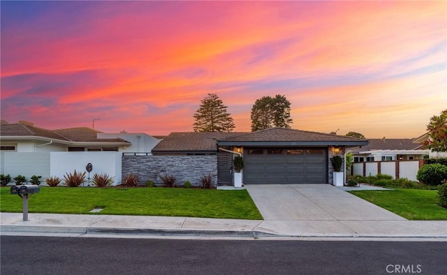 35 Beachcomber Dr, Corona Del Mar, CA 92625 - view of front facade featuring driveway, an attached garage, stone siding, and stucco siding