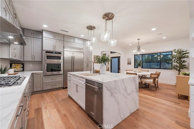 35 Beachcomber Dr, Corona Del Mar, CA 92625 - kitchen featuring appliances with stainless steel finishes, gray cabinetry, under cabinet range hood, light wood-style floors, and arched walkways