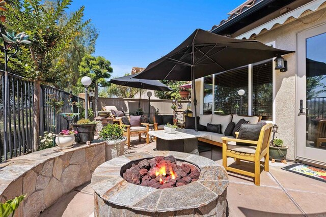 6130 Paseo Monona, Carlsbad, CA 92009 - fenced backyard featuring a patio and an outdoor living space with a fire pit