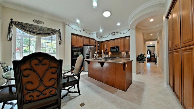 6130 Paseo Monona, Carlsbad, CA 92009 - kitchen with black appliances, crown molding, brown cabinets, a kitchen breakfast bar, and a kitchen island with sink