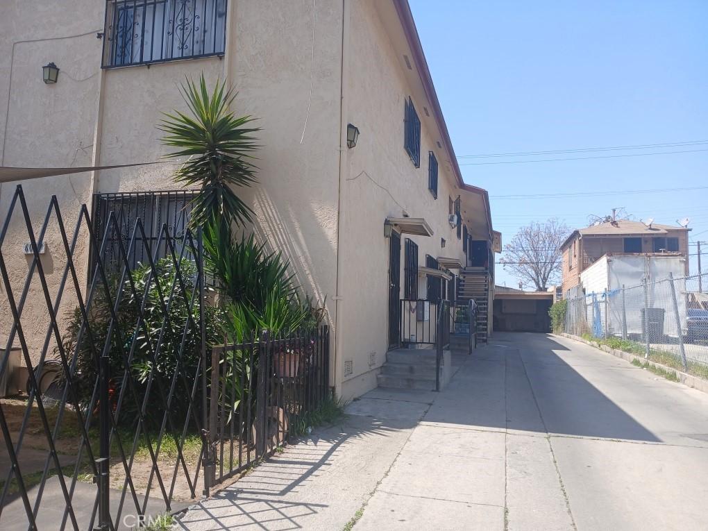 6027 Makee Ave, Los Angeles, CA 90001 - view of home's exterior with stucco siding, crawl space, and concrete driveway