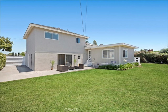 18643 Las Flores St, Fountain Valley, CA 92708 - back of property featuring an outdoor hangout area, a patio area, a yard, entry steps, and stucco siding