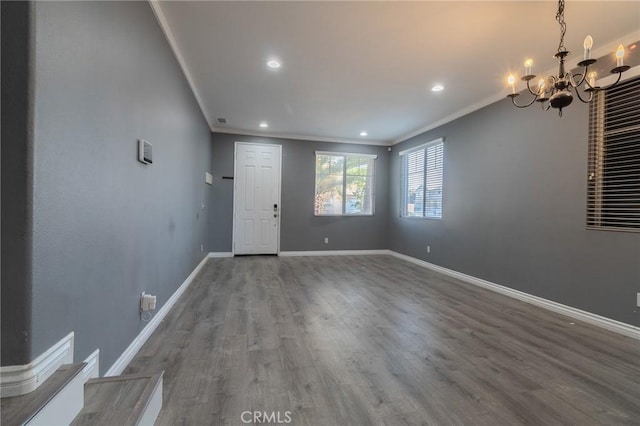 13740 Starshine Dr, Victorville, CA 92392 - foyer featuring ornamental molding, a chandelier, wood finished floors, and recessed lighting