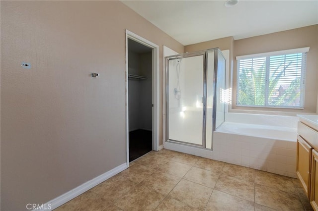 13740 Starshine Dr, Victorville, CA 92392 - bathroom with a shower stall, a spacious closet, a garden tub, and vanity