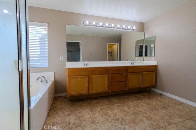 13740 Starshine Dr, Victorville, CA 92392 - full bathroom featuring double vanity, a garden tub, tile patterned flooring, and a spacious closet