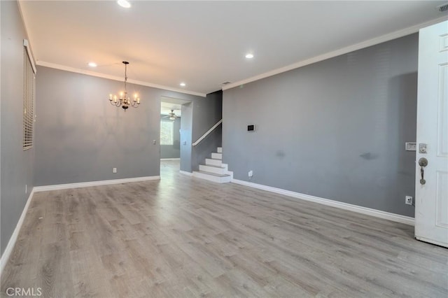 13740 Starshine Dr, Victorville, CA 92392 - spare room with ornamental molding, a chandelier, recessed lighting, stairway, and wood finished floors