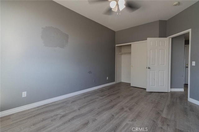 13740 Starshine Dr, Victorville, CA 92392 - unfurnished bedroom with wood finished floors, a closet, and a ceiling fan
