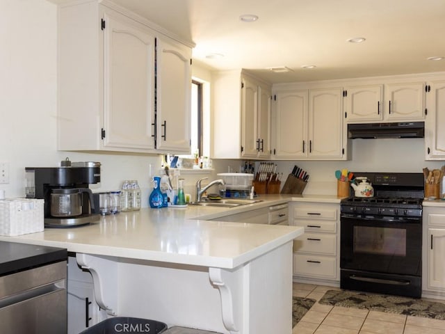 7491 Kingsbury Rd, Templeton, CA 93465 - kitchen with black gas stove, under cabinet range hood, a peninsula, a kitchen bar, and light countertops