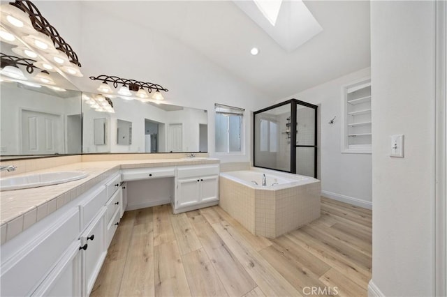 40132 White Leaf Ln, Murrieta, CA 92562 - full bath featuring a skylight, vaulted ceiling, double vanity, a stall shower, and a bath