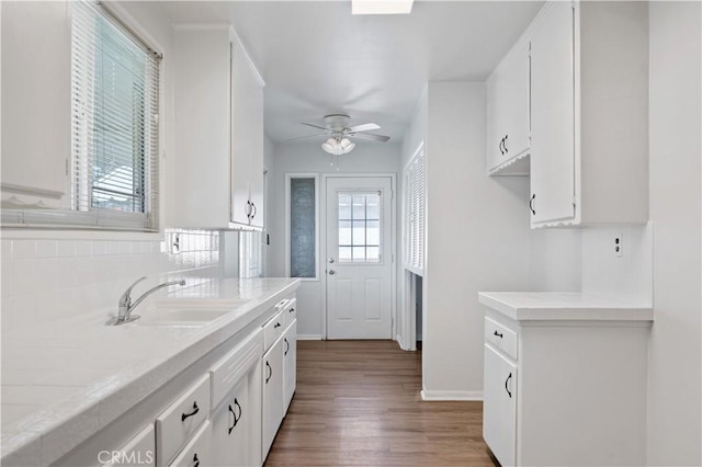 513 W D St, Wilmington, CA 90744 - kitchen with light countertops, wood finished floors, white cabinets, and ceiling fan