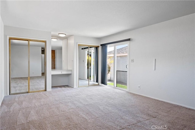 513 W D St, Wilmington, CA 90744 - unfurnished bedroom featuring multiple closets, carpet floors, and access to exterior