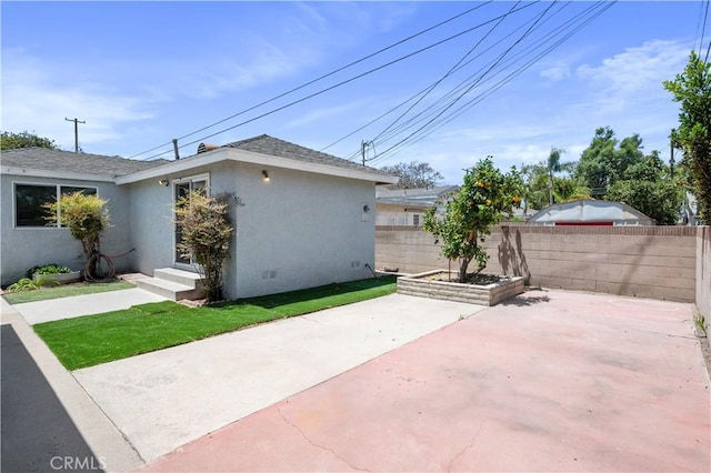 513 W D St, Wilmington, CA 90744 - view of home's exterior featuring stucco siding, a patio, and a shingled roof