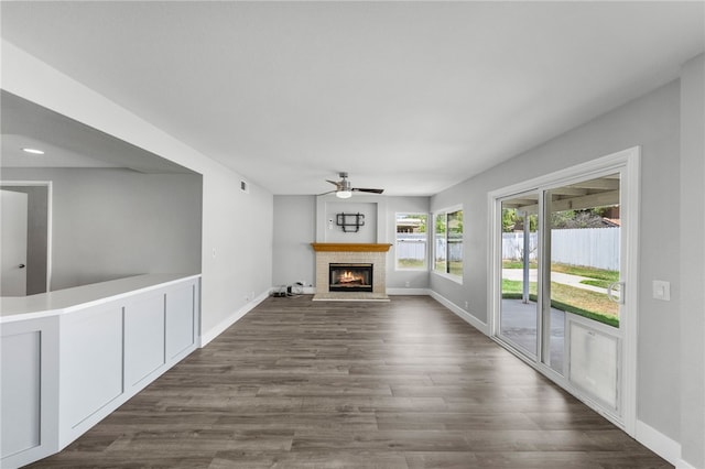 7250 Goldboro Ln, Riverside, CA 92506 - unfurnished living room with ceiling fan, a fireplace, and dark wood-style flooring