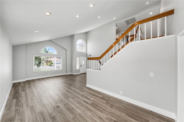 7250 Goldboro Ln, Riverside, CA 92506 - unfurnished living room with recessed lighting, stairs, wood finished floors, and lofted ceiling
