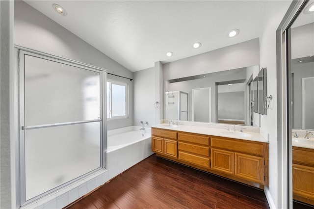 7250 Goldboro Ln, Riverside, CA 92506 - full bath featuring lofted ceiling, double vanity, a garden tub, wood finished floors, and a shower stall