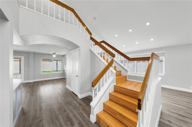 7250 Goldboro Ln, Riverside, CA 92506 - staircase featuring wood finished floors, arched walkways, ceiling fan, and recessed lighting