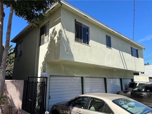 824 Redondo Ave, Long Beach, CA 90804 - view of side of home featuring stucco siding, a garage, and a gate